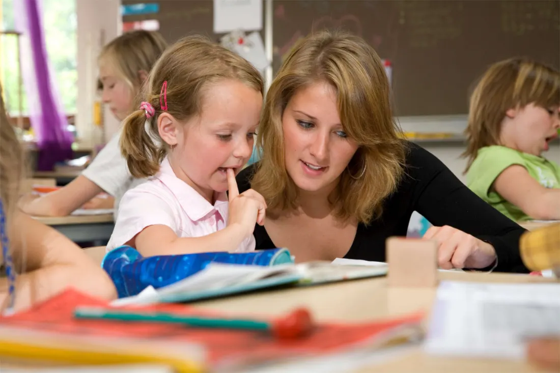 Een leerkracht en leerlingen aan het werk in de klas